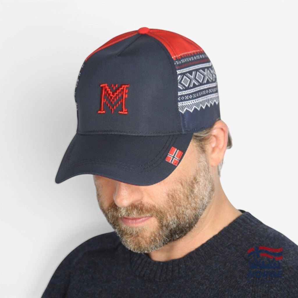 Fanshoppen Norge navy blue baseball cap with red embroidered 'M' logo and traditional Norwegian pattern on sides. Red brim.