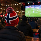 Fanshoppen Norge red, white, and blue knitted beanie with Norwegian flag design and pom-pom.