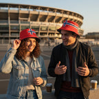 Fanshoppen Norge red bucket hat with white and blue stripes, featuring the Norwegian flag design. A woman with curly hair wears it while reading a book.