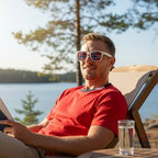 Fanshoppen Norge white sunglasses with Norwegian flag lenses, worn by a man.